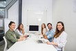 © WavebreakMediaMicro - Portrait of smiling executive in conference room during meeting