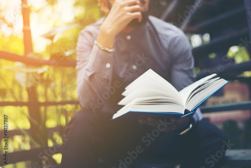 Fotomural Young handsome beard man reading book