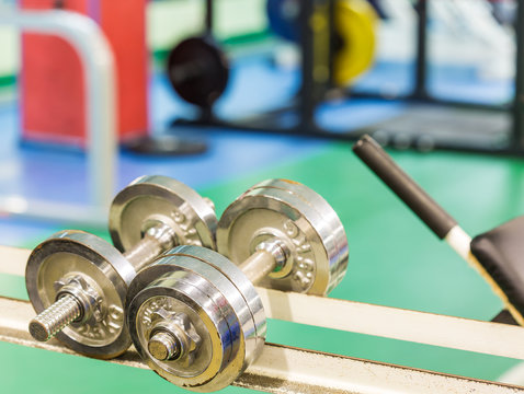iron dumbbells on a stand in gym