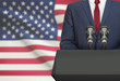 Businessman or politician making speech from behind a pulpit with national flag on background - United States