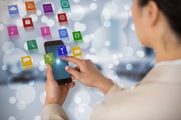 Poster - Composite image of businesswoman using mobile phone 3d
