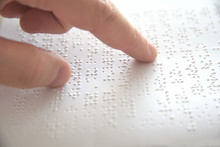 Hand Of A Blind Person Reading Some Braille Text Touching The Relief. Empty Copy Space For Editor's Content.