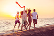 © FS-Stock - Group of happy young people is running on background of sunset beach and sea