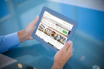 Poster - Composite image of businessman using his tablet 