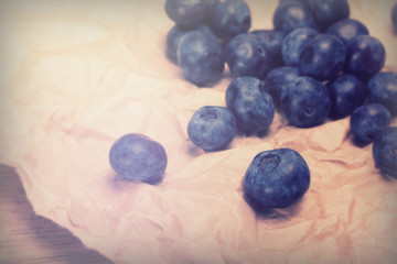 Wall Mural - Fresh blueberries on a rustic brown paper background