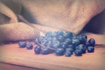 Wall Mural - Blueberries and spoon on a rustic background