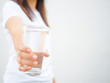 © Siam - A glass of clean mineral water in woman's hands. Concept of environment protection, healthy drink.