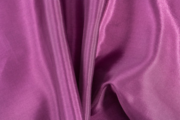 Silk background, texture of amaranth color  shiny fabric