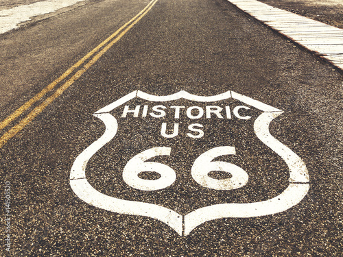 Fotografia, Obraz Historic US Route 66 highway sign on asphalt in Oatman, Arizona, United States