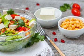 Healthy homemade vegan chickpea salad with vegetables and tofu. Love for a healthy vegan food concept