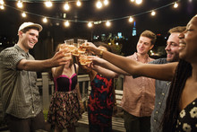 Young People Raising Toast At Party