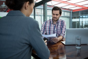 Business executive conducting job interview with woman