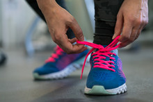 Running Shoes - Woman Tying Shoe Laces. Woman Getting Ready For Engage In The Gym