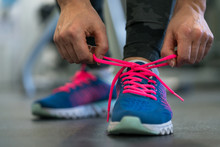 Running Shoes - Woman Tying Shoe Laces. Woman Getting Ready For Engage In The Gym