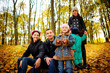 © cezarksv - Parents look at children in autumn park