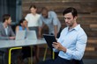 © WavebreakMediaMicro - Business executive using digital tablet in office