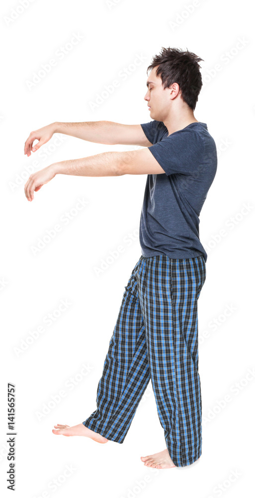 Young sleepy man suffering from somnambulism on white background