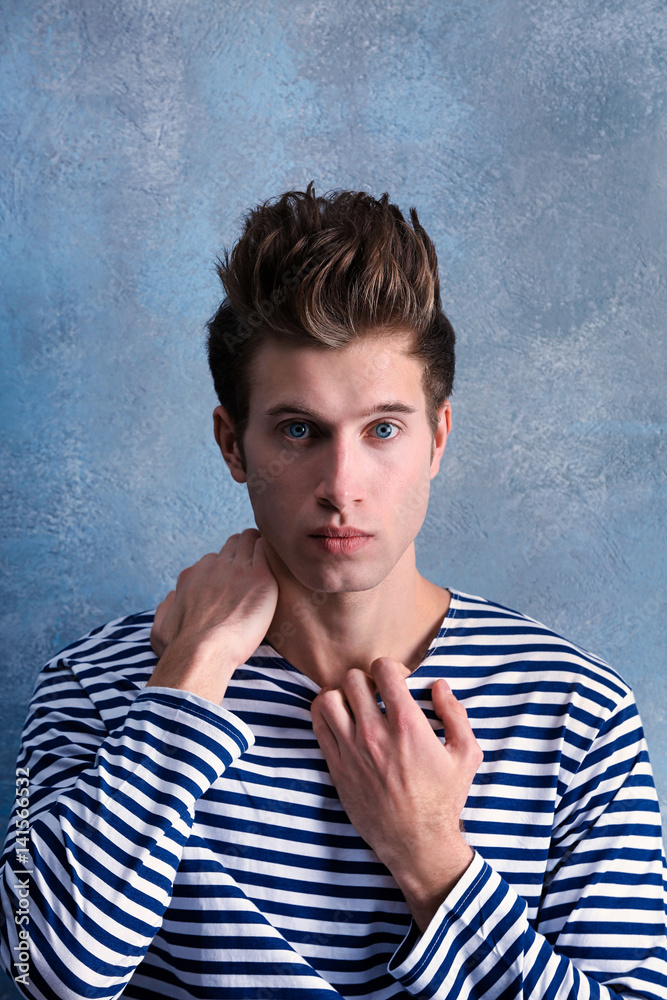 Handsome young man on color background