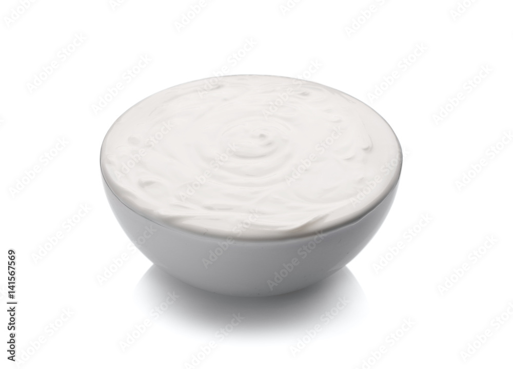 Bowl of delicious yogurt on white background