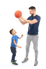 Wall Mural - Handsome man and his son playing basketball on white background