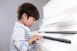 Leinwandbild Motiv Asian Chinese little boy playing piano at home