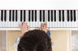 Leinwandbild Motiv Aerial view of Asian Chinese little boy playing piano