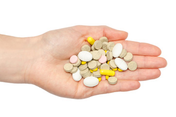 Wall Mural - hand of young girl holding pills.