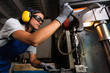 © ADDICTIVE STOCK - female mechanic operating a column type drill