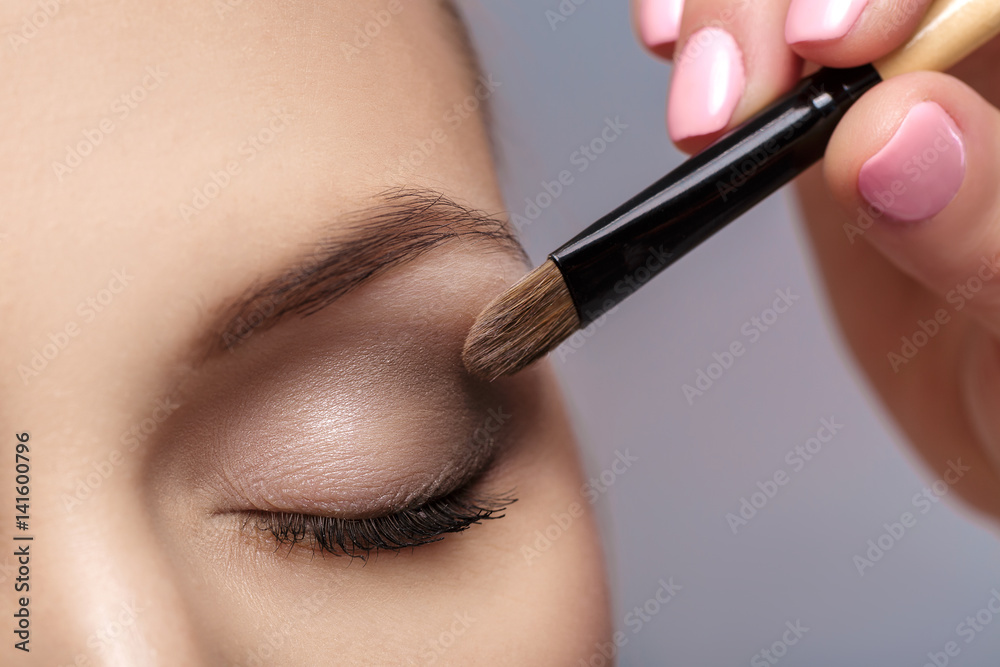 makeup artist apply makeup brush for eyes. makeup for young girl. brown eye shadow. close up - obrazy, fototapety, plakaty 