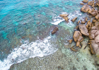 Wall Mural - Seychelles Island La Digue aerial top view of a coastline with turquoise sea and granite rocks