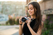 © Kike Arnaiz/ADDICTIVE STOCK - Smiling young woman adjusting camera