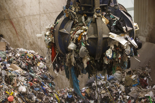 Fotografia, Obraz Mechanical claw hand grabbing pile of mixed waste