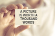 © stanciuc - Businessman holding A PICTURE IS WORTH A THOUSAND WORDS message card