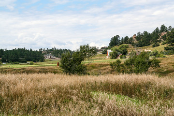 Field with barn and houses in the distance