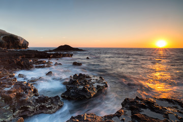 Colorful sunset at pristine untouched island destination in Mexico with beautiful breaking waves