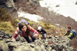 © Cavan Images - High angle view of friends climbing mountain