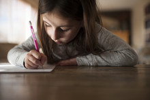 Girl Writing Homework At Home