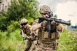 Two military man snipers with airsoft automatic rifle