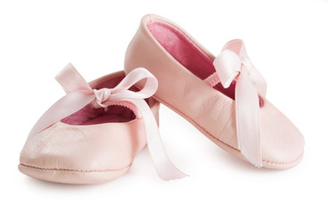 Pair of pink ballet shoes with bowknot for newborn baby. Isolated on a white background close up.