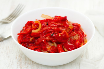 grilled red pepper with onion salad on white bowl