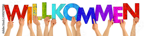Fotografie, Obraz People holding up colorful letters shaping the german word welcome / willkommen
