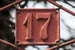 Old retro weathered cast iron plate with number 17