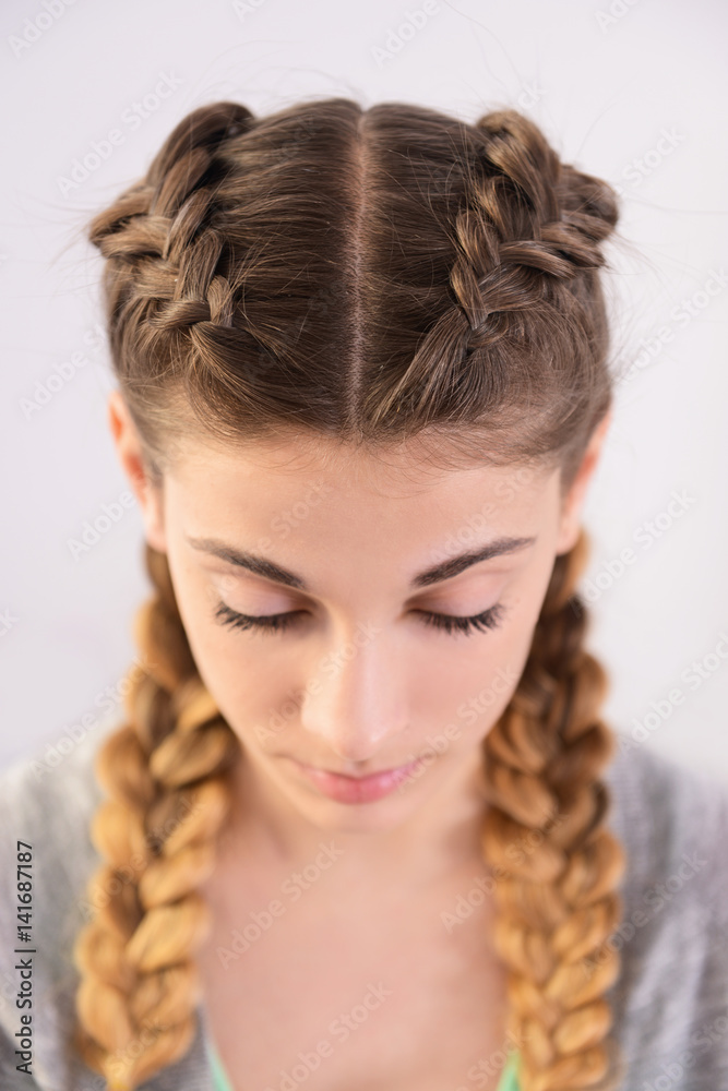 Young woman with beautiful hairstyle on light background