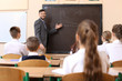 © Africa Studio - Pupils listening teacher in classroom