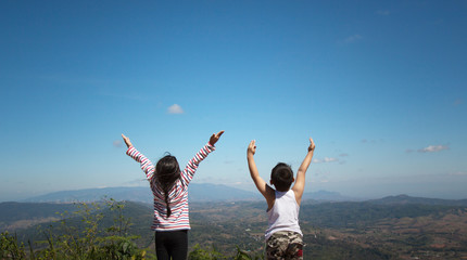 Canvas Print - Two little children raise their arms up to the sky. They feel free