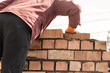 © schankz - Worker builds a brick wall in the house