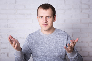 Wall Mural - portrait of young man talking about something over white wall