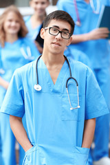 Poster - Young male student with groupmates outdoors