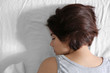 © Africa Studio - Depressed young woman lying in bed at home, closeup