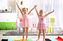Cheerful Little Girls Playing At Home